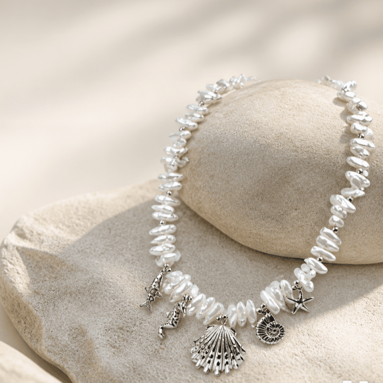 Κολιέ Ocean Pearl με λευκές πέρλες φυσικής αισθητικής και ασημί θαλασσινά charms. Ένα κομψό καλοκαιρινό κόσμημα εμπνευσμένο από τη θάλασσα