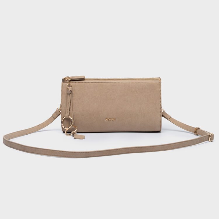 Ανακαλύψτε τη γυναικεία τσάντα Nolah Aura Beige. Κομψό design σε μπεζ απόχρωση με χρυσές λεπτομέρειες & δώρο charm. Έρχεται σε πολυτελή συσκευασία δώρου!