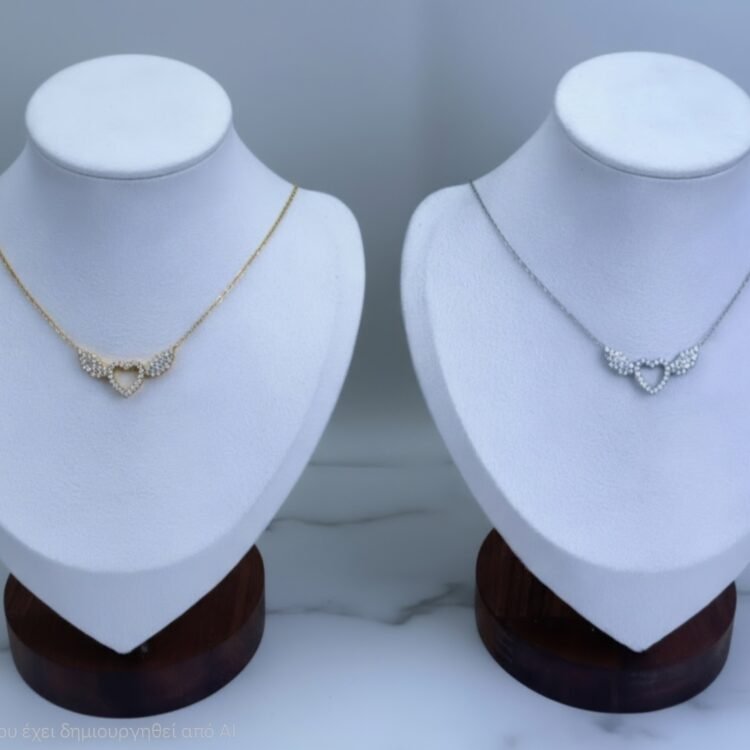 Seraphine Necklace κομψό κολιέ με καρδιά που κρατιέται από δύο φτερά και λαμπερά ζιργκόν. Διαθέσιμο σε χρυσό και ασημί, ιδανικό για κάθε εμφάνιση.